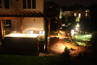Image: Tier One Landscape outdoor room, pond, and landscape lighting.